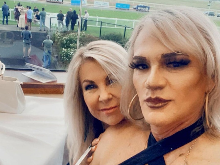 Two women, including Dani Laidley, smiling for a photo with a racecourse in the background.