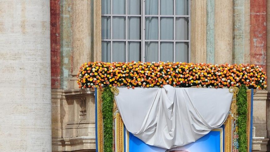 The giant banner bearing John Paul II's portrait is unveiled over the facade of St Peter's basilica