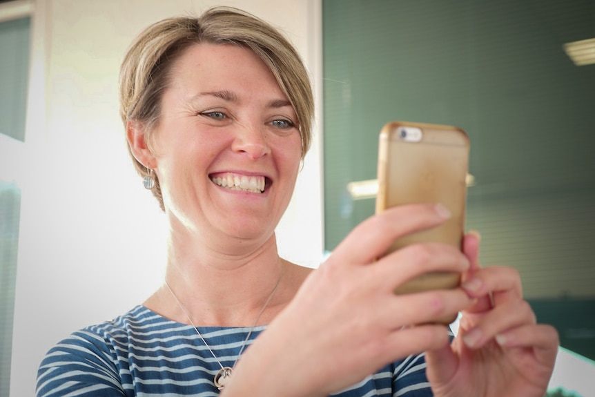 Woman holding up phone