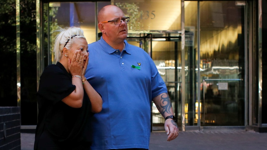 Charlotte Charles holds her head in her hands alongside Tim Dunn, as they leave studios.