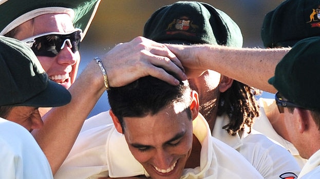 Mitchell Johnson is congratulated by team-mates