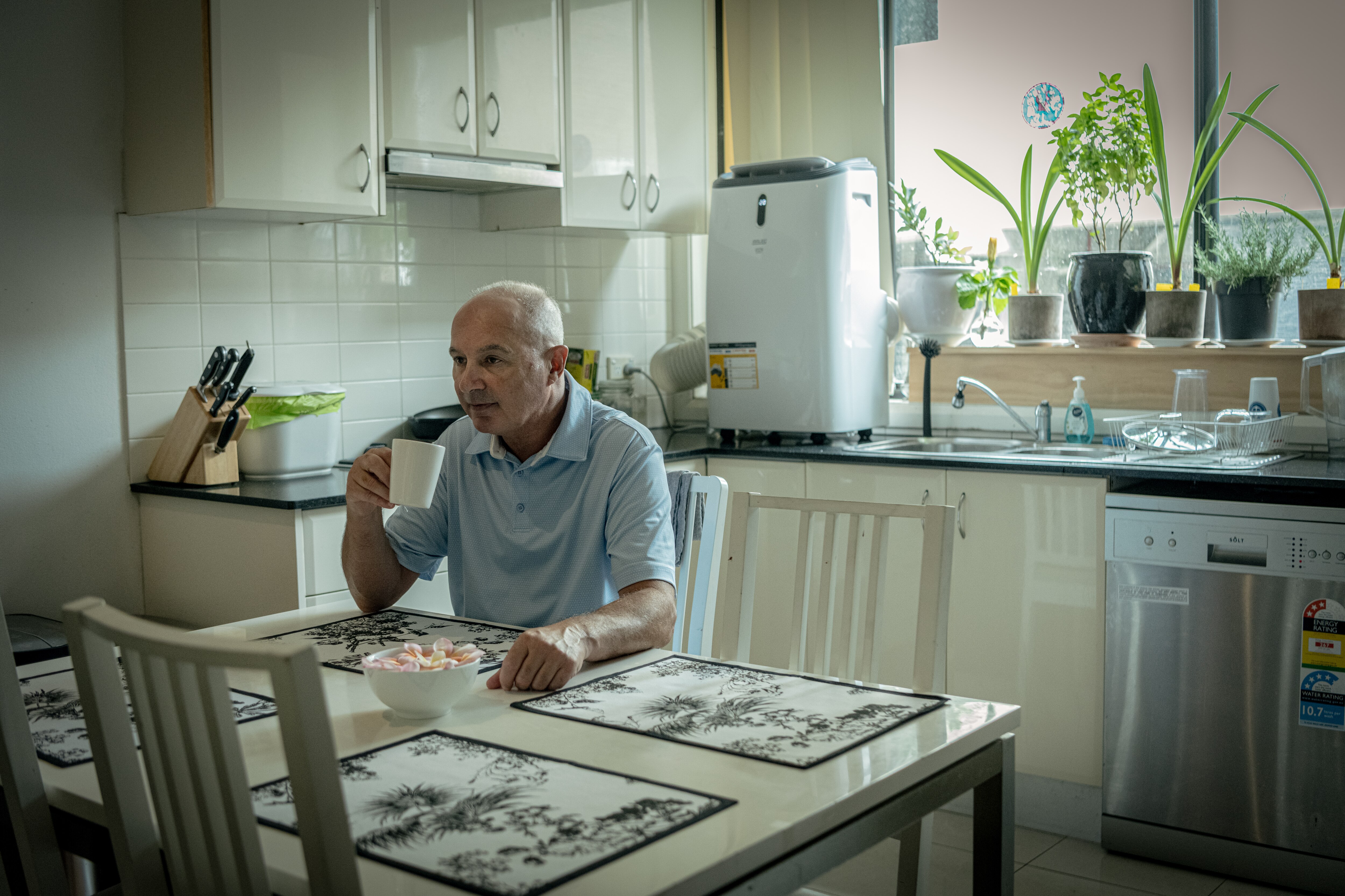 Long COVID sufferer Tim Stannard sits at his dining table.