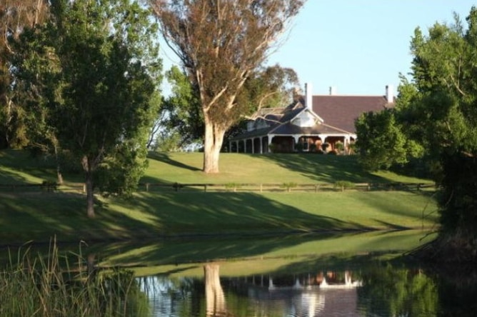 A large house surrounded by gardens.