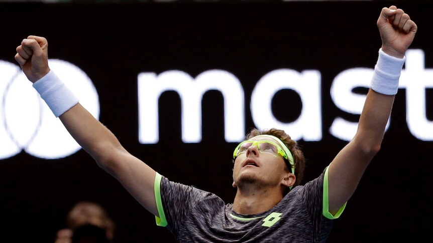 Denis Istomin celebrates beating Novak Djokovic