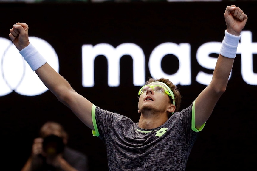 Denis Istomin celebrates beating Novak Djokovic