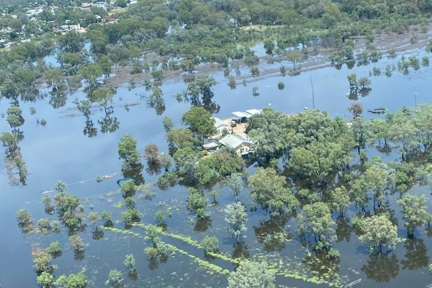A house photographed from the air surrounded by floodwater 