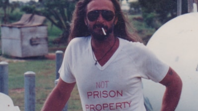 Terry Irving in a shirt that says 'not prison property'.