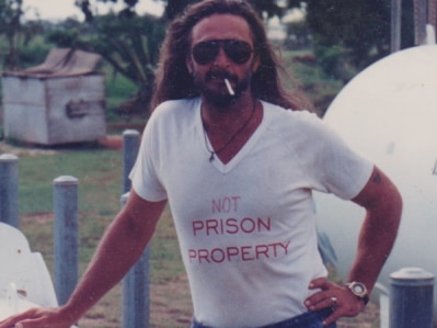 Terry Irving in a shirt that says 'not prison property'.