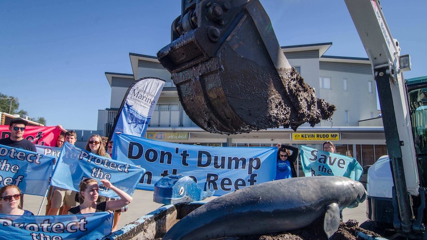 Activists dump sludge and a fake dugong outside Prime Minister Kevin Rudd's Brisbane office
