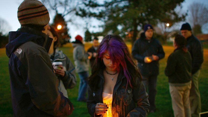 People take part in a vigil for victims