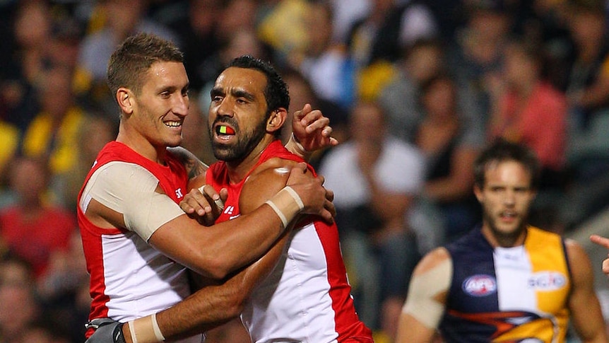 Staying power ... the Eagles hung tight with the Swans but Adam Goodes (r) was heavily involved in getting Sydney in front for good.