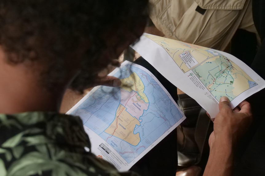 Man reads maps printed on A4 paper