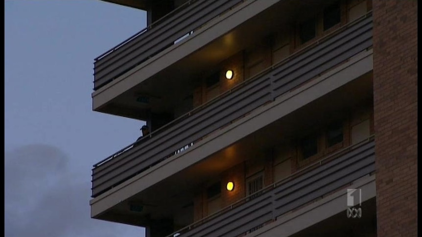 The man fell from a high-rise building on Sunday morning in Brisbane's CBD when he tried to 'plank' on a balcony railing.