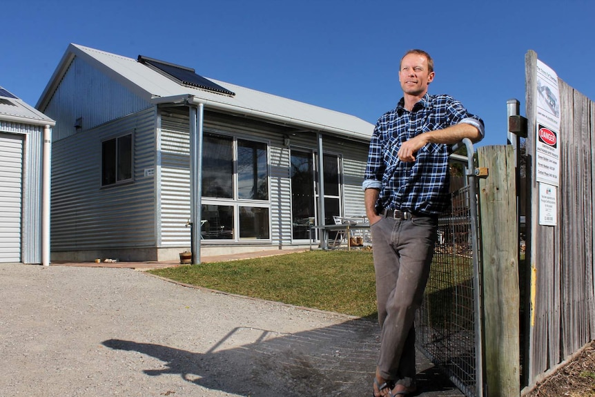 Andy Lemann stands out the front of his Greeny Flat.