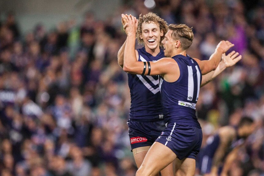 Chris Mayne (L) and Tommy Sheridan celebrate another goal to the Dockers against North Melbourne.