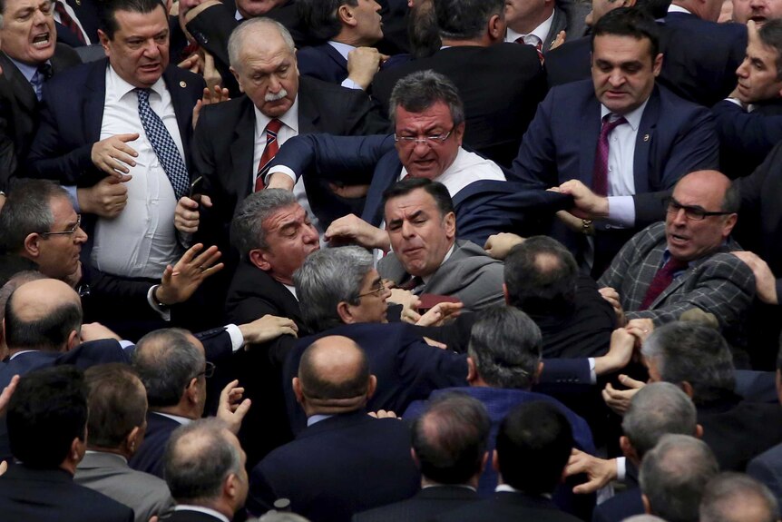 Turkish politicians scuffle in parliament during deliberations over a controversial package of constitutional amendments.