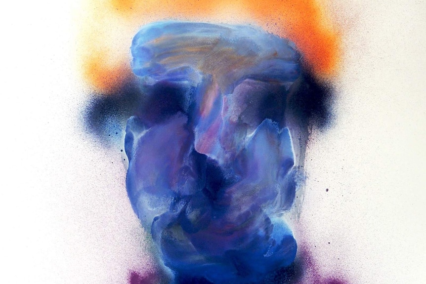 A blue spray painted portrait of a person wearing a purple shirt with orange hair.