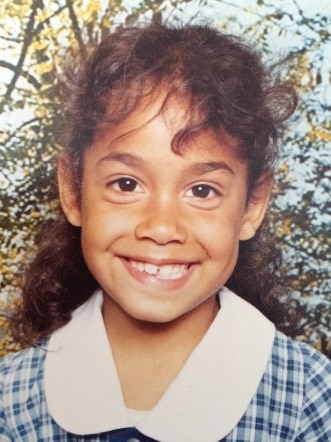 A school photo of an Kindergarten-aged girl. 