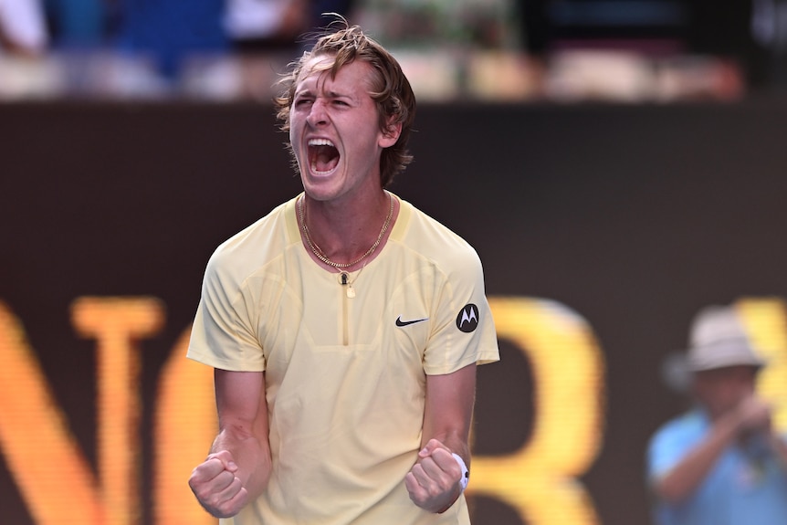 An American male tennis player screams out in joy after winning an Australian Open match.