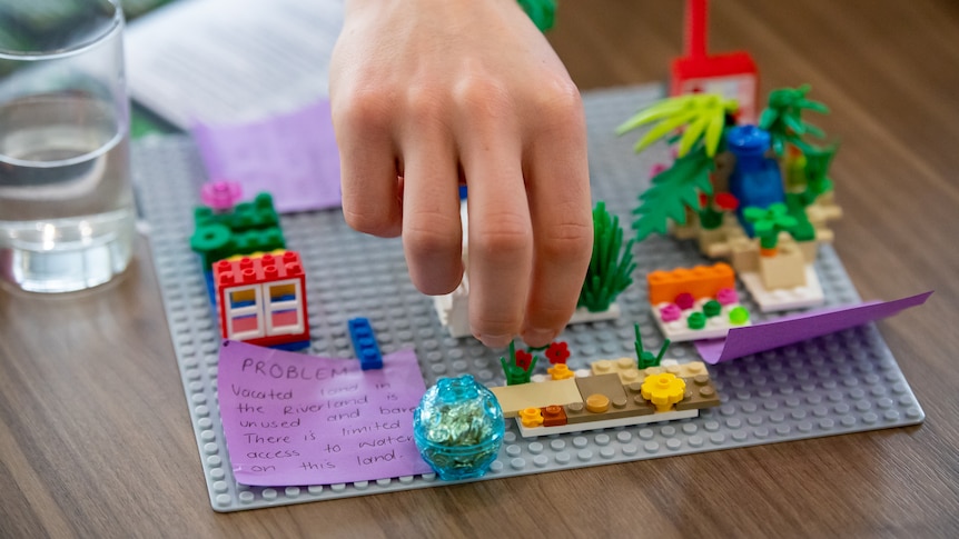 A high school student creates a solution to a vacant land use issue using lego.