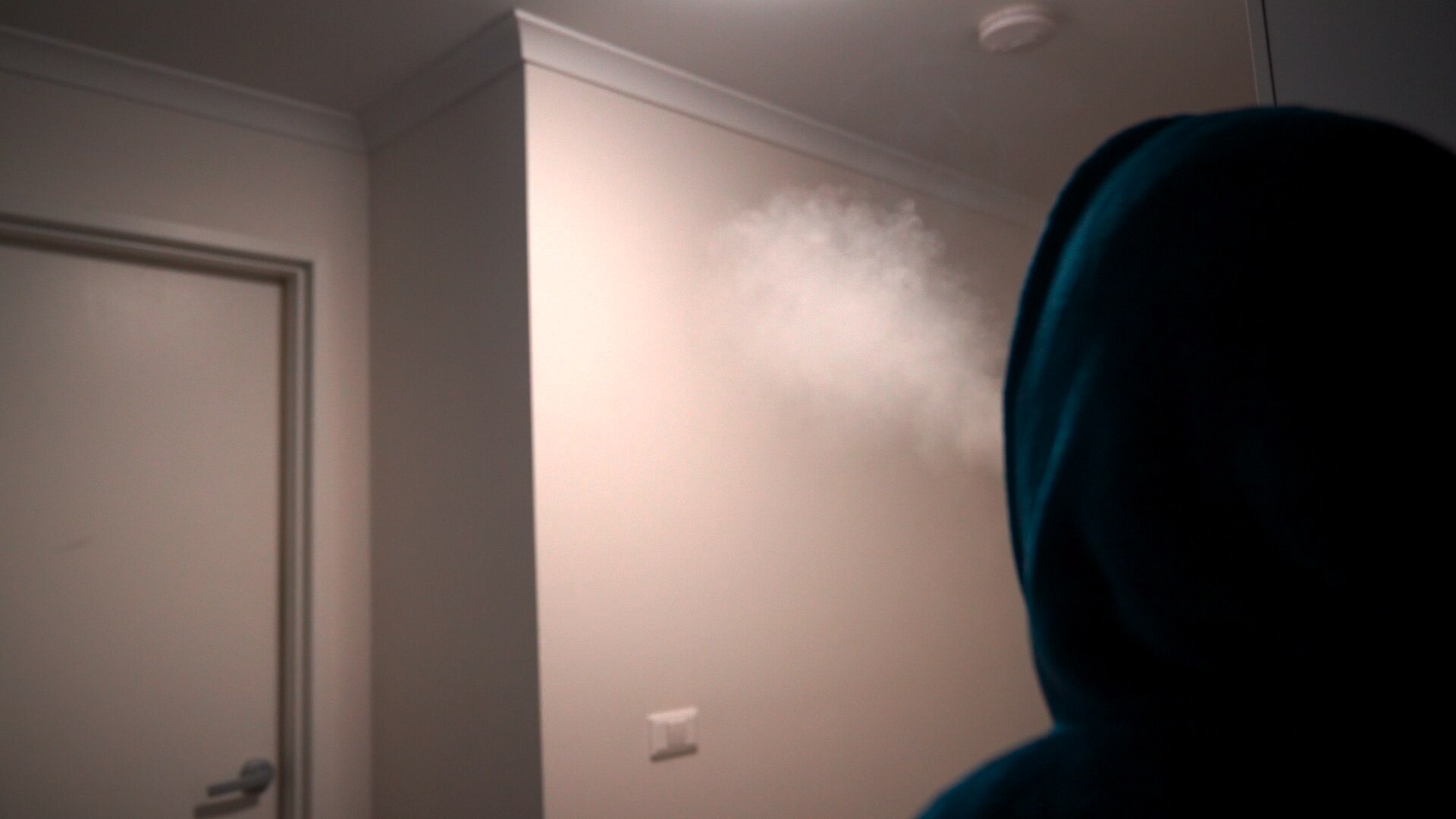 Man exhaling cannabis smoke