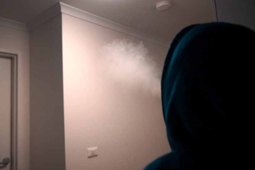 Man exhaling cannabis smoke