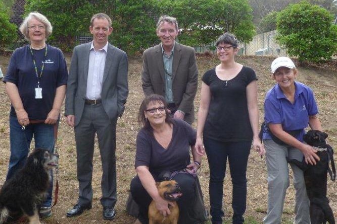 di johnstone and shane rattenbury with domestic animal services volunteers and dogs
