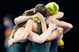 Australia's women's 4x100m medley relay team hug after the Commonwealth Games final.
