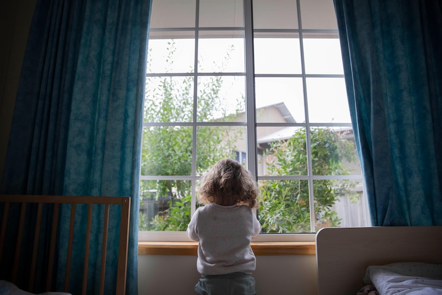 A child looking out of a window.