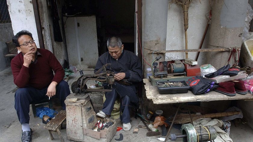 A Chinese cobbler repairs shoes