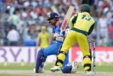 Virat Kohli plays a sweep shot against Australia, as Matthew Wade keeps behind the stumps.