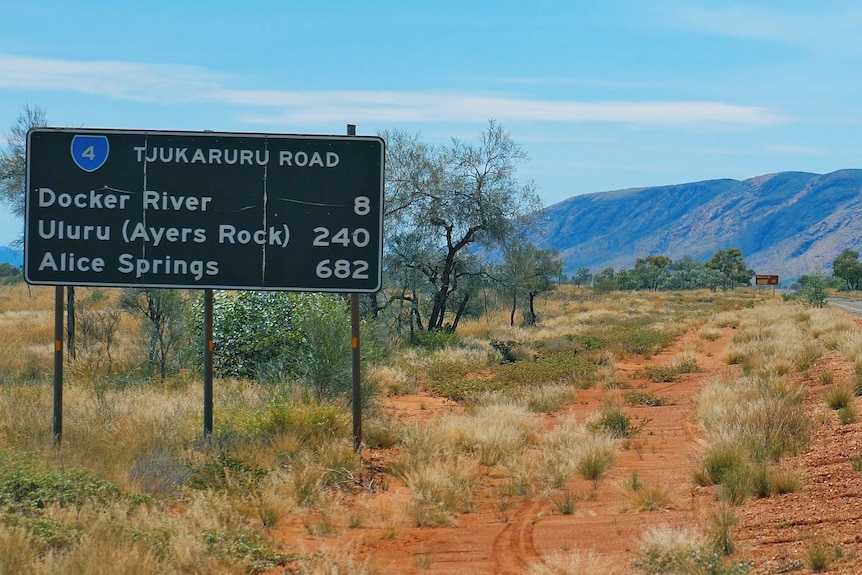 Road sign with Docker River, Uluru, Alice Springs