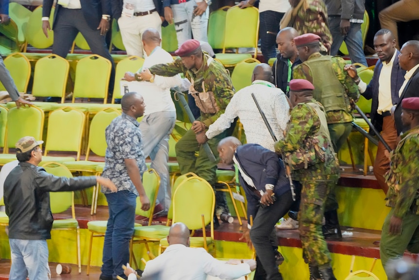 Riot police try to calm the supporters of Raila Odinga in the presidential race.
