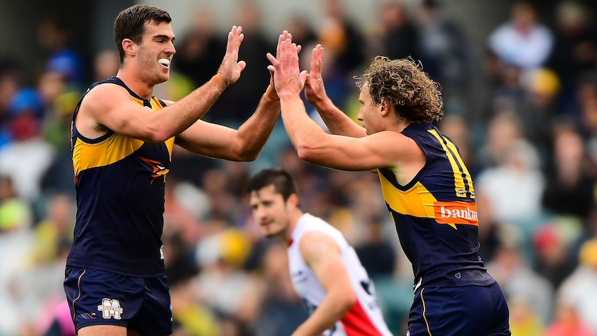 West Coast's Scott Lycett (L) and Matt Priddis celebrate a goal against Melbourne at Subiaco Oval.