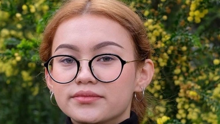 Protrait of a woman with glasses in a black turtleneck 