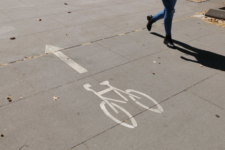 A woman walks on a shared path in Acton.