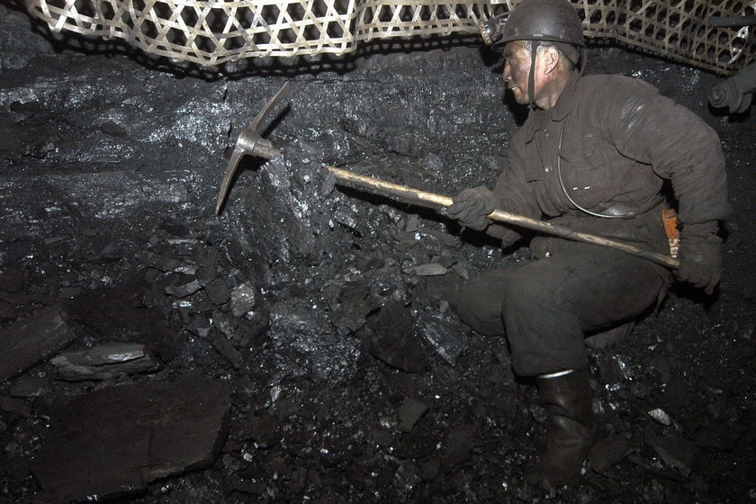 A miner works at the Xinyuan coal mine at Qinyuan county