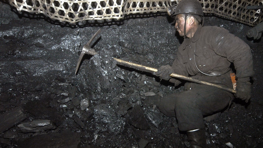 A miner works at the Xinyuan coal mine at Qinyuan county