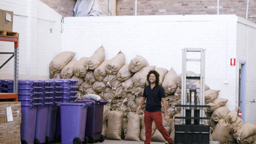 Sustainable Salons Australia co-founder stands in front of materials packed for recycling.