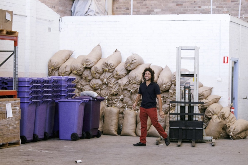 Sustainable Salons Australia co-founder stands in front of materials packed for recycling.