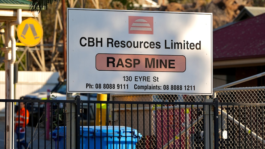 A sign reading "CBH Resources Limited Rasp Mine". Workers are visible behind it.
