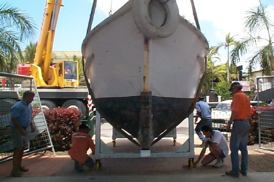 a boat being hoisted by a crane