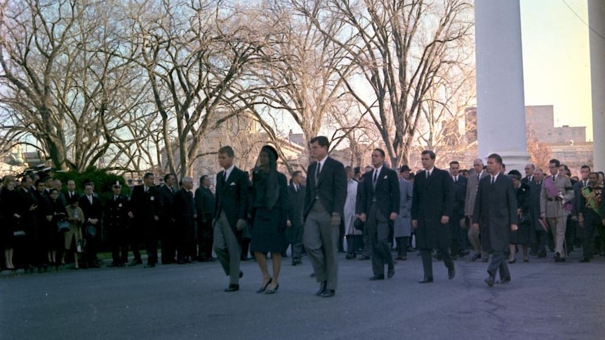 Members of the Kennedy family lead the funeral procession for JFK from the White House.