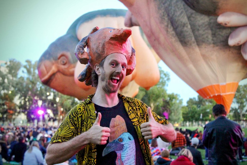 Man wearing papier mache hat