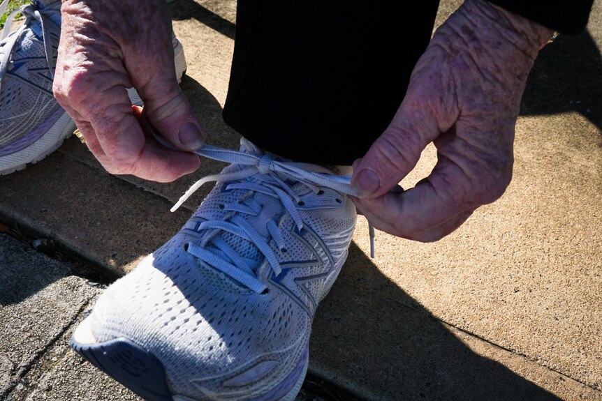 Hands tying up runner shoelaces