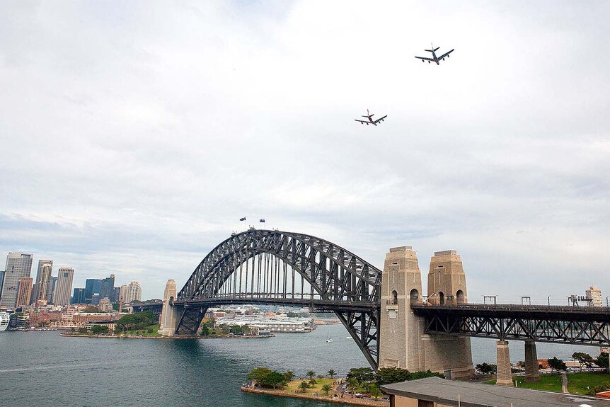 A pair of A380s fly low over Sydney Harbour