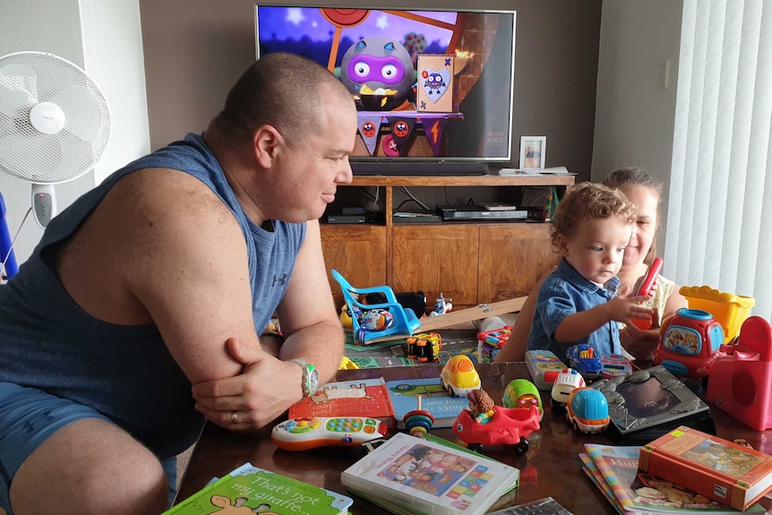 Roger and Karen Stern play with their son Zachery in their apartment