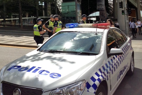 Police at Southern Cross Station, where an area has been cordoned off for an unattended package.