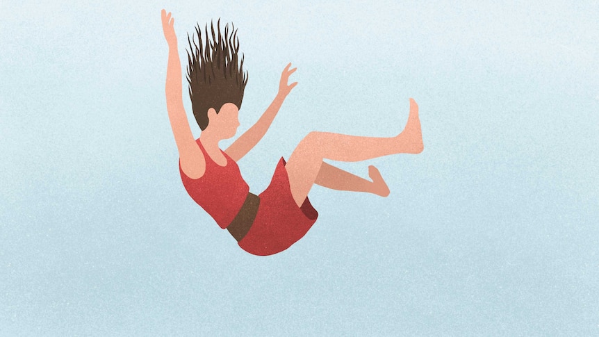 A woman falling against a blue background