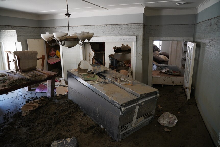 Damaged furniture in a room due to floodwaters.